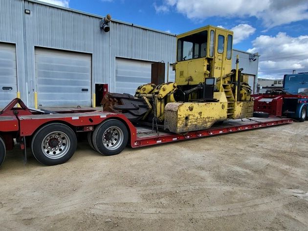 Tracked equipment loaded on a lowboy trailer